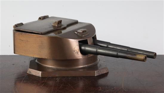 A 1920s brass inkwell modelled as a battleship gun turret cast from the scrapped German battleship Helgoland(-)